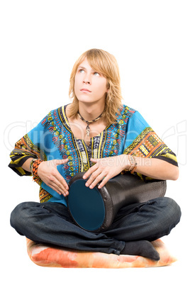 The young man plays a drum looking upwards