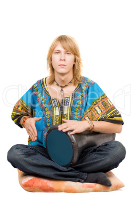 The young man plays a drum. Isolated