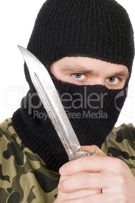 Portrait of the criminal in a black mask with a knife