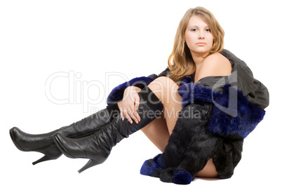 The young beauty woman in a fur coat and boots