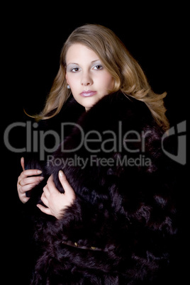 The young beautiful woman in a fur coat