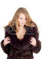 The young beautiful woman in a fur coat over white