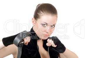 Pretty young angry woman throwing a punch