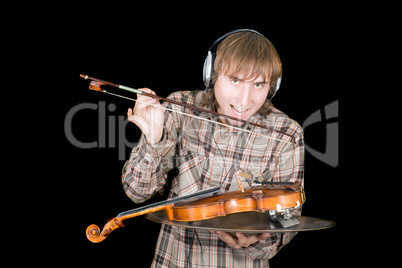 The young man in ear-phones eats a violin