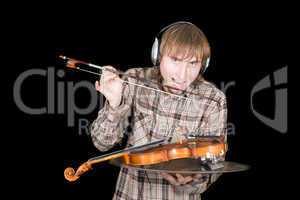 The young man in ear-phones eats a violin