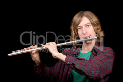 The young man plays a flute over black