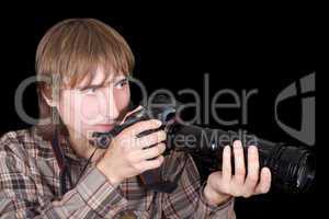 Young  photographer with the camera with a zoom lens