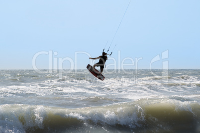 Kite surfer silhouette, jumping and flying