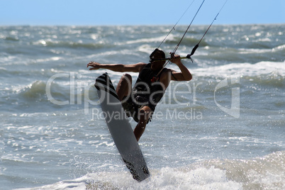 Kite surfer jumping and flying high