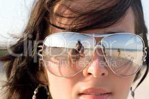 Reflexion of the photographer in model glasses