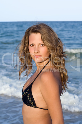 Portrait of the beautiful girl against the sea