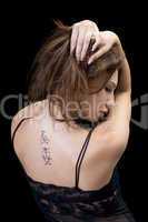 Tattoo on a back of the young woman