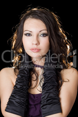 Beautiful young woman in a violet dress over black