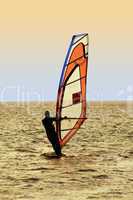 Silhouette of a windsurfer on waves of a sea