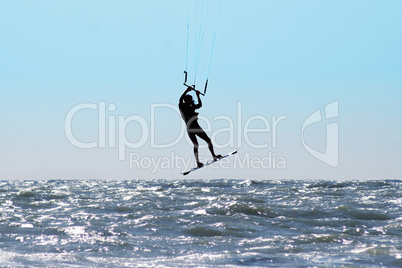 Silhouette of kite surfer in a sea