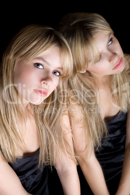 Young blonde and her reflection in a mirror