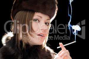 Portrait of the beautiful young woman with a cigarette