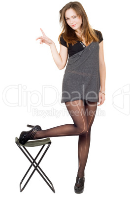 Young woman in the torn stockings and a chair. Isolated
