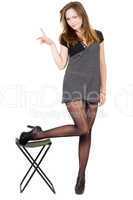 Young woman in the torn stockings and a chair. Isolated