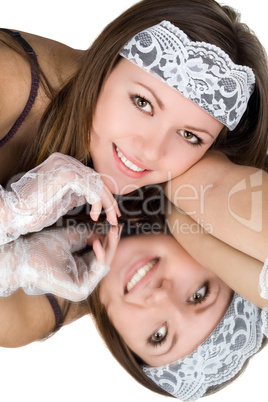 Portrait of the young woman laying on a mirror