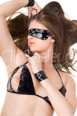 Sexy young woman in handcuffs and a bandage on eyes over white