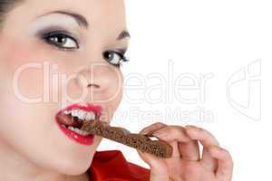 Portrait of the beautiful young woman eating chocolate