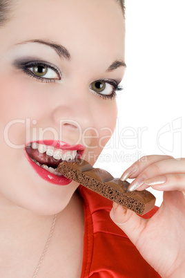 Portrait of the young woman eating chocolate