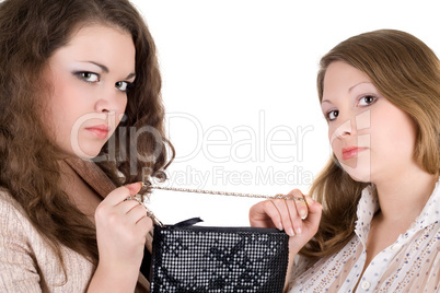 Quarrel of two beautiful girls because of a handbag