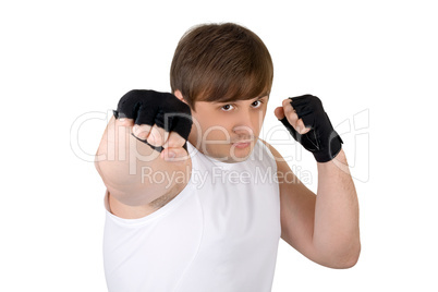 Young man throwing a punch. Isolated on white