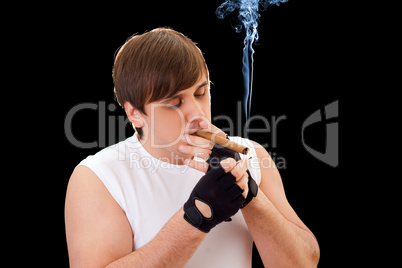 Young man sets fire to a cigar