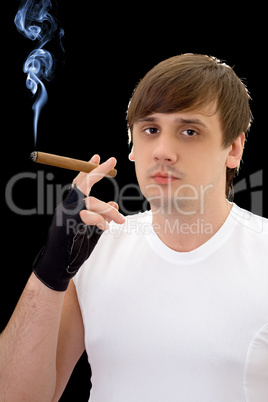 Young man with cigar. Isolated on black