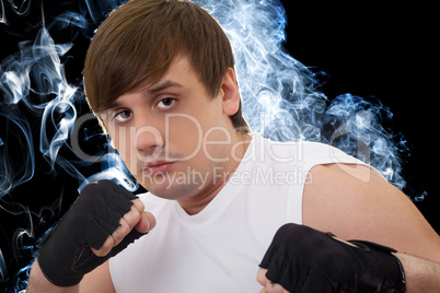 Portrait of the young fighter in a smoke