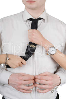 Young man, a tie and female hands. Isolated on white