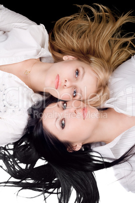 Portrait of the two pretty blonde and brunette