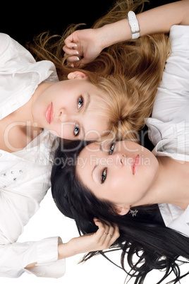 Portrait of the two lying attractive girls