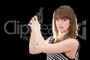 Beautiful young woman with pistol. Isolated on black