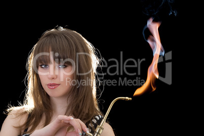 Portrait of the young woman with a gas torch