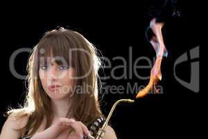 Portrait of the young woman with a gas torch