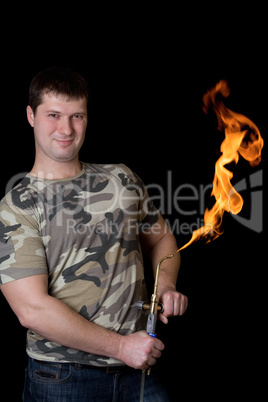 Strong young man with a gas torch