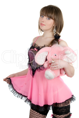 Playful girl in a pink dress with the elephant calf