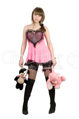 Pretty girl in a pink dress with plush toys