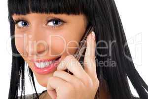 Portrait of the smiling girl speaking on the phone
