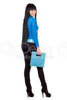 Pretty girl with a blue handbag. Isolated