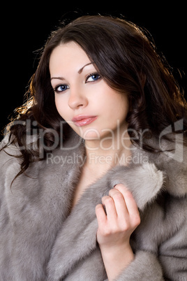 Young pretty woman in a fur coat