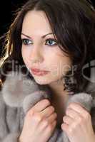 Pretty young woman in a fur coat