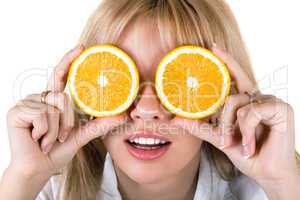 Portrait of the funny young woman with oranges. Isolated