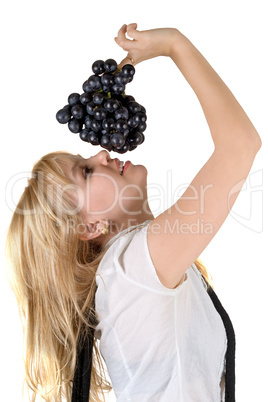 Portrait of the smiling girl with grapes cluster. Isolated