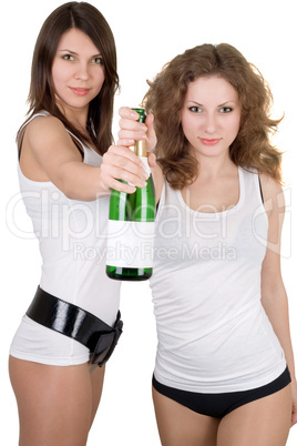 Two beautiful girls with a champagne bottle. Isolated