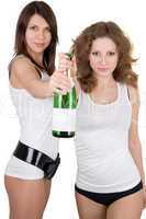 Two beautiful girls with a champagne bottle. Isolated