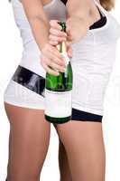 Two girls with a champagne bottle. Isolated